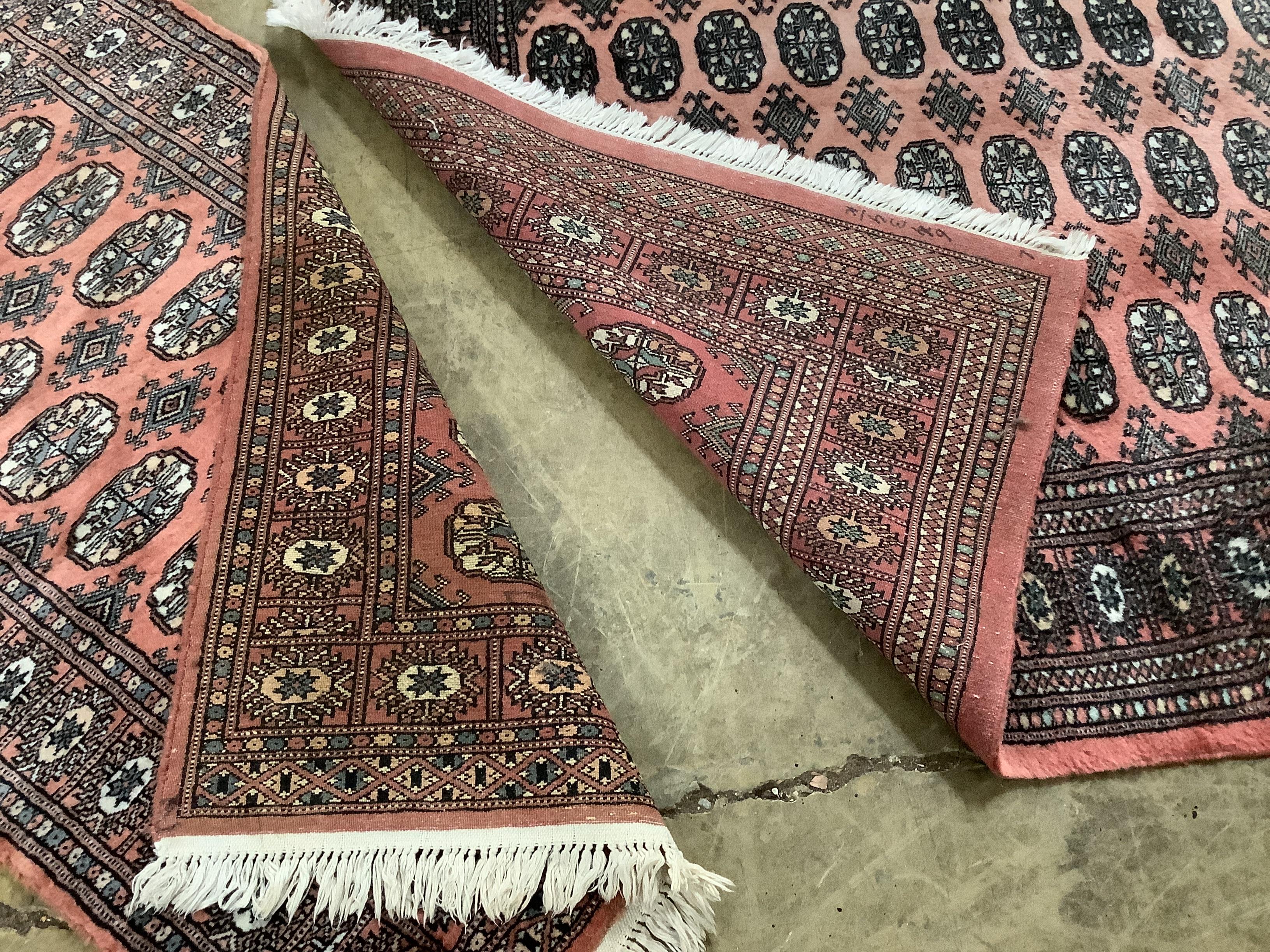 Two Bokhara peach ground rugs, larger 178 x 124cm